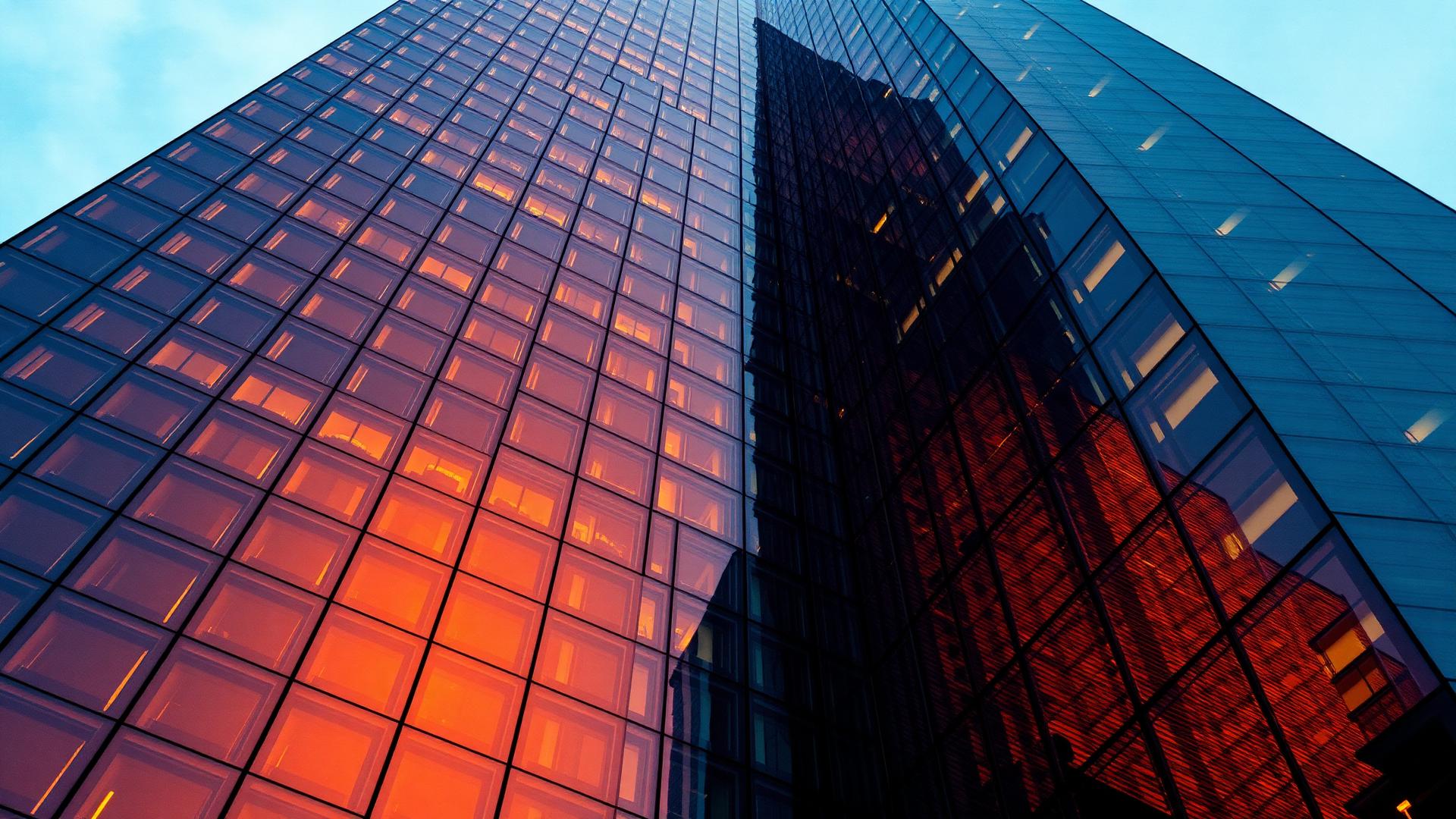 Sunlight raking across a modern glass building facade